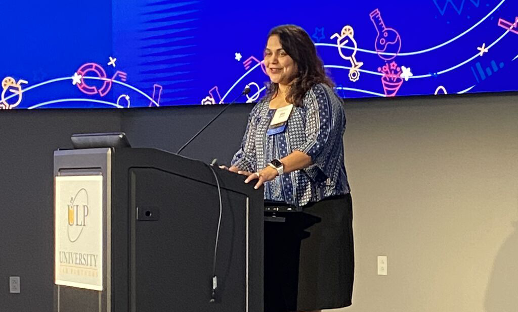 Uma Lakshmipathy speaking at podium